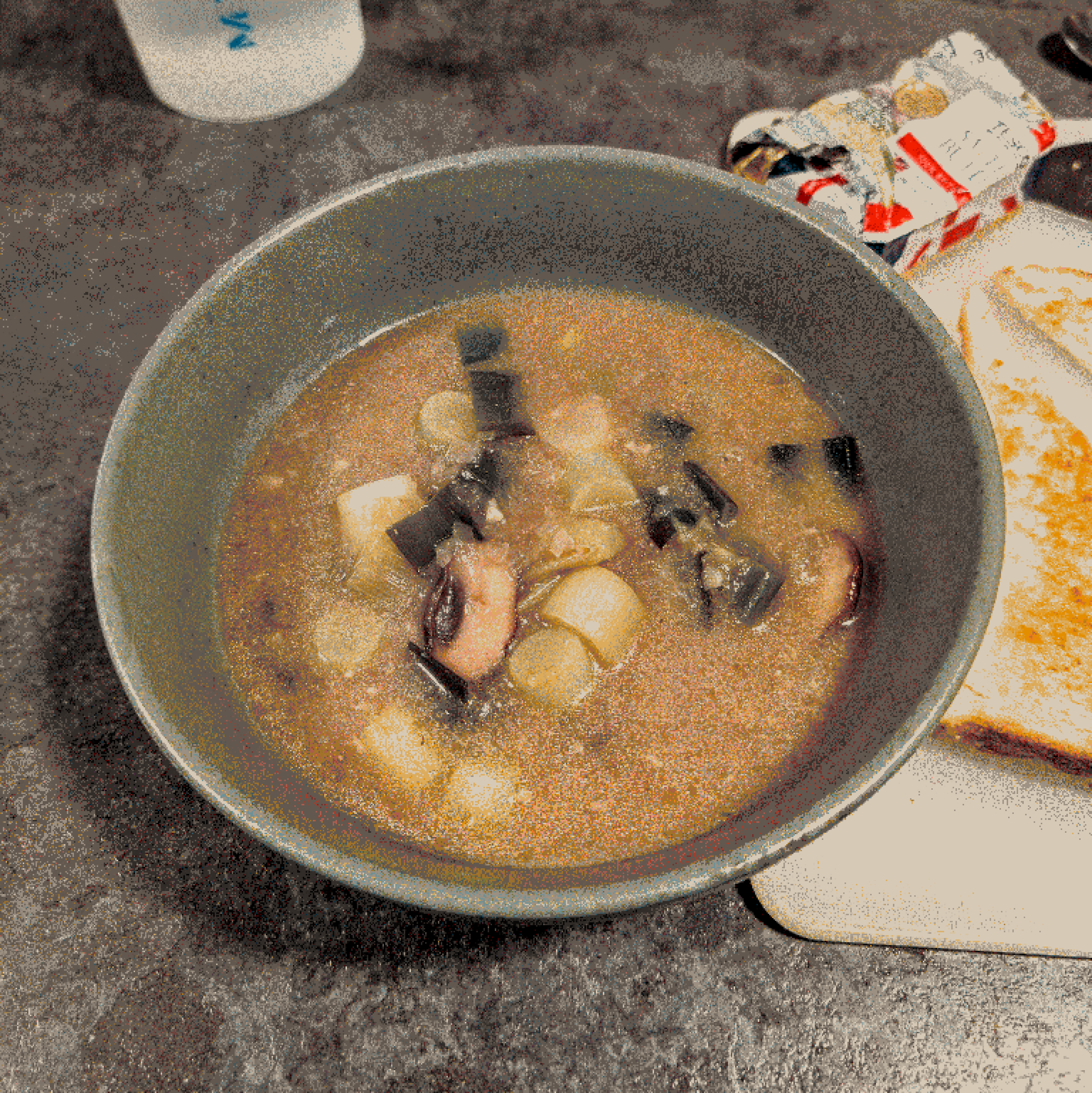 Mushroom and leek miso soup in a green bowl